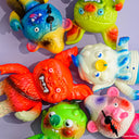 6 soft vinyl monster-like figures that are brightly colored. Characters include a bat, a bear and an octopus.