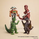 Four toy figures of dinosaurs and a robot on a beige background
