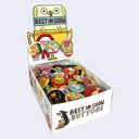 Box of 'Best in Show' buttons with colorful designs on a white background