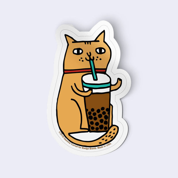 Sticker of a cat holding a bubble tea with a straw on a light gray background