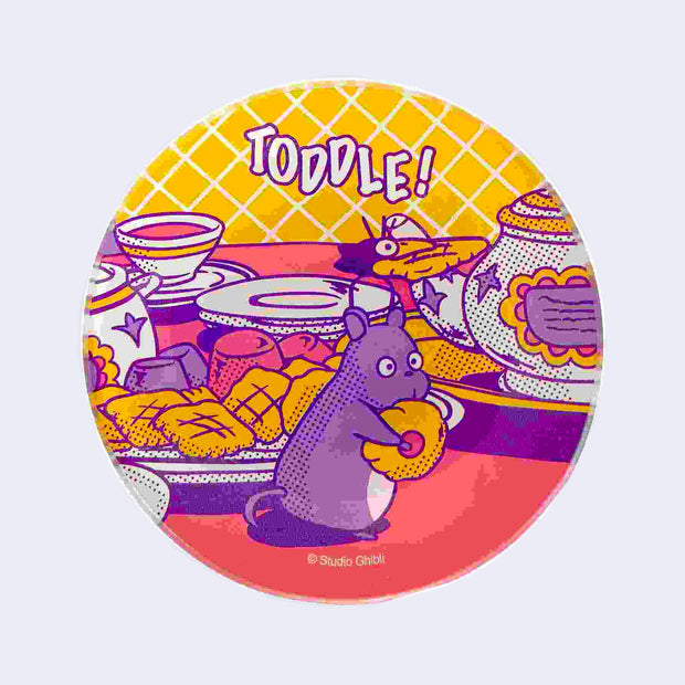Colorful pink, purple and yellow glass plate with imagery from Spirited Away of small characters, a mouse and a bird, taking sweets away on a table top with tea and baked goods.