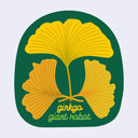 Semi oval shaped green sticker with an illustration of 3 yellow-orange gingko leaves forming a pattern. Text in cursive below reads "ginkgo / giant robot"