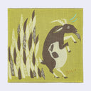 Square green fabric handkerchief with an artistic illustration of a goat standing on its hind legs in front of tall grains.