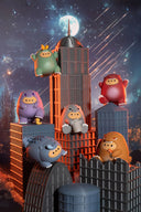 Colorful cartoon potato figurines dressed as Godzilla on top of stylized city buildings with a night sky background.