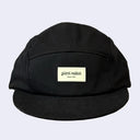 A black five-panel camp cap with a beige rectangular patch on the front reading 'giant robot since 1994', shown against a light gray background.