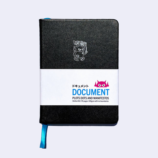 Black pleather covered sketchbook with a small embossment of a robot carrying a flag that reads "Giant Robot" in the upper center. Paper sleeve reads "Document Plots Dots and Manifestos."