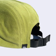 Back view of green cap, with adjustable strap to change fit.