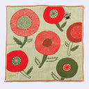 Greenish beige square handkerchief with a small black bumblebee flying over large rounded red and green flowers.
