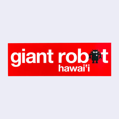 Red rectangular bumper sticker that says "giant robot" with the final o being a black standing robot instead. Below and slightly offset says "hawai'i"