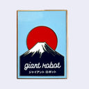 A rectangular enamel pin featuring a light blue background with a red sun, a white and black mountain silhouette, and the words 'giant robot' in white script with Japanese text below, shown on a plain light gray background.