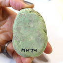 Sculpture seen from underneath with the artist's signature.