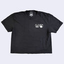 Black t-shirt with a small white graphic on a light gray background