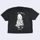 Black t-shirt with a white graphic design on a light gray background
