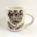 White mug with floral design on a white background