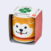 Small cup shaped planter, with a graphic of a dog's face on it, smiling with its tongue out.