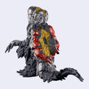 A detailed collectible figure of a monstrous, smog creature with a melting black body, 2 red glowing eyes, yellow accents, and outstretched arms. Its back is colored red, gold and black.