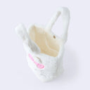 Fluffy white faux fur handle bag with Hello Kitty's face on the front, she has 3D fluffy ears, a pink box and kawaii eyes. Seen from overhead to show closure and inner pocket.