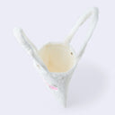 Fluffy white faux fur tote bag with Hello Kitty's face on the front, she has 3D fluffy ears, a pink box and kawaii eyes. Open and seen from overhead.