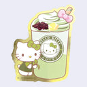 A Hello Kitty die-cut sticker featuring a matcha green drink topped with whipped cream, a pink bow, and red beans alongside an illustration of Hello Kitty in a green outfit holding a leaf. The sticker has a gold foil border and visible Sanrio copyright text at the bottom.