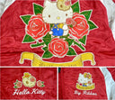 Close up detailing of Hello Kitty satin bomber jacket with Hello Kitty themed embroidering - on the back a large depiction of Hello Kitty sitting with roses, on the front 2 lapel patches of skulls with roses and Hello Kitty.