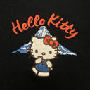 Embroidered patch of Hello Kitty with a mountain on a black background