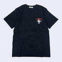 Navy blue t-shirt with a small graphic and text on a light gray background