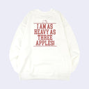 Back view of a white sweatshirt with text in all caps reading "I am as heavy as three apples!" with a small line art graphic of Hello Kitty's head appearing along the top of the text block.