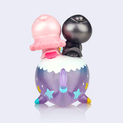  Vinyl figure of Sanrio's Little Twin Stars, a pink haired girl and a blue haired boy, riding atop of a smiling purple narwhal. Back view.
