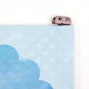 Painting on canvas of a sunset time with a silhouette of the tops of roofs and trees at the bottom. The scene is enclosed in a scalloped border with blue polkadots. 