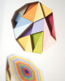 Colorful geometric paper sculpture on a white background