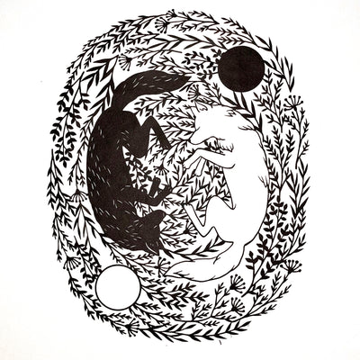 Black paper cutting art of 2 wolves, one black and the other white, resting opposite one another like a yin and yang symbol. They are on a nest of leaves, going in a circular direction.
