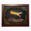 Assembled paper cutting diorama of a fox, jumping over a mountain range and against a starry night sky. It is framed by many cut leaves, revealing the scene. Piece is in open shadowbox style wooden frame.