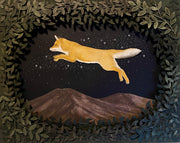 Assembled paper cutting diorama of a fox, jumping over a mountain range and against a starry night sky. It is framed by many cut leaves, revealing the scene.