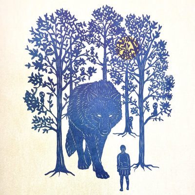 Cut dark blue paper artwork of a large wolf, walking towards a small woman. It emerges from many trees with small forest spirits in them.