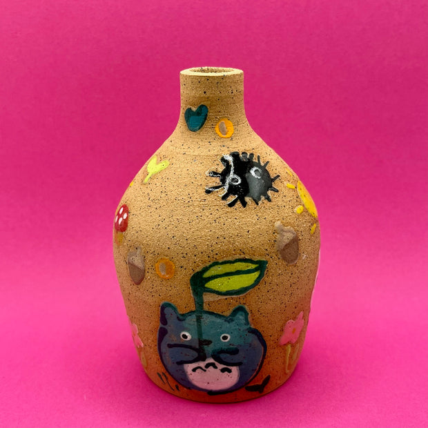 Stoneware vase, with small cute illustrations of My Neighbor Totoro themed doodles, such as dust sprites, chibi Totoros, leaves, acorns and mushrooms.