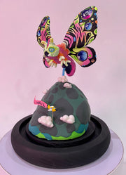 Mixed media sculpture of a large psychedelically colored moth, with large eyes hovering over a rounded land mass. A small helicopter flies around the mound with a banner that reads "All Hail"