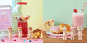 6 small figurines of Kewpie Babies with diner themed items atop their heads - such as burgers, hot dogs, coffee, milkshake, condiments, etc.