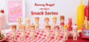 Sonny Angel mini figure snack series featuring 12 figures and 2 special designs on a checkered tablecloth with condiments in the background.