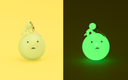 Glowing green character keychain on a yellow and black background