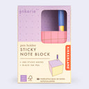 Kikkerland sticky note block packaging with pen holder on a light purple background