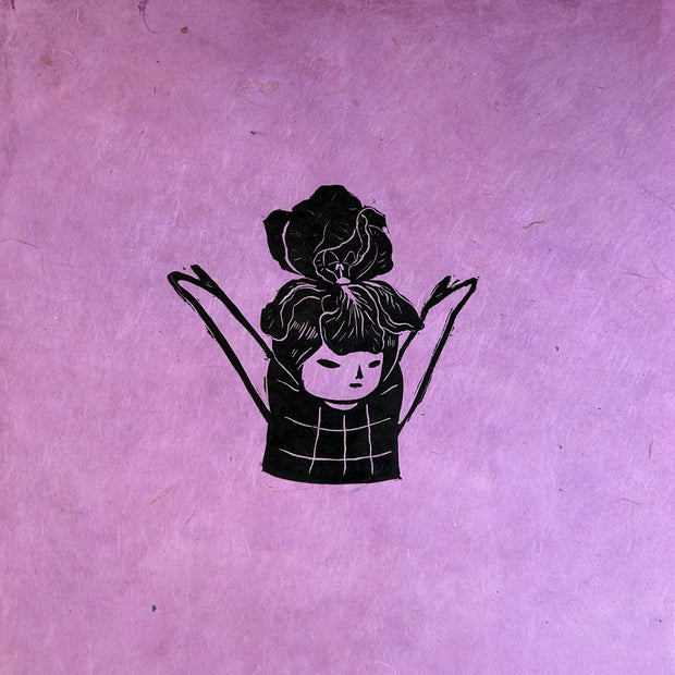 Black ink linocut print on purple fibrous paper of a small girl in a plaid shirt with her arms lifted up. Atop her head is a large iris flower.