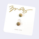 Back view of pin card with the 2 goldware backings and a signature from artist James Jean.