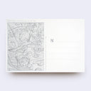 Backside of a white postcard divided into two sides, one with a sketch style illustration and the other side 4 lines to write a note on.