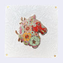 Enamel pin of a red horse with a mane made out of flowers.