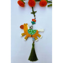 Tassel hanging of a flat clay sculpture of a brown and white horse with beads on a green tassel.