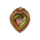 A heart-shaped gold pendant or brooch featuring a cartoon illustration of a man with a long nose and brown hat on a green background, shown against a plain white backdrop.