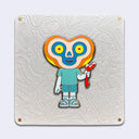 Die cut gold outlined enamel pin of a character with a bean shaped head and the body of a human child. Its eyes are yellow and red and its face is outlined yellow, orange, tan and blue. It holds a red twig and wears striped sneakers.