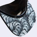 Close up of the underside of a snapback cap. The underside of the bill has a sublimated pattern of several centipedes with many legs, no head.