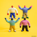 Four action figures wearing colorful sweaters on a yellow background
