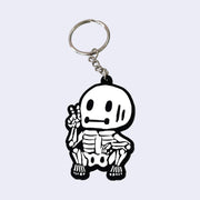 Keychain with a cartoon skeleton design on a light gray background